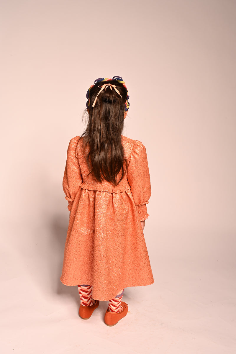 girls orange sparkly smocked dress with long sleeves