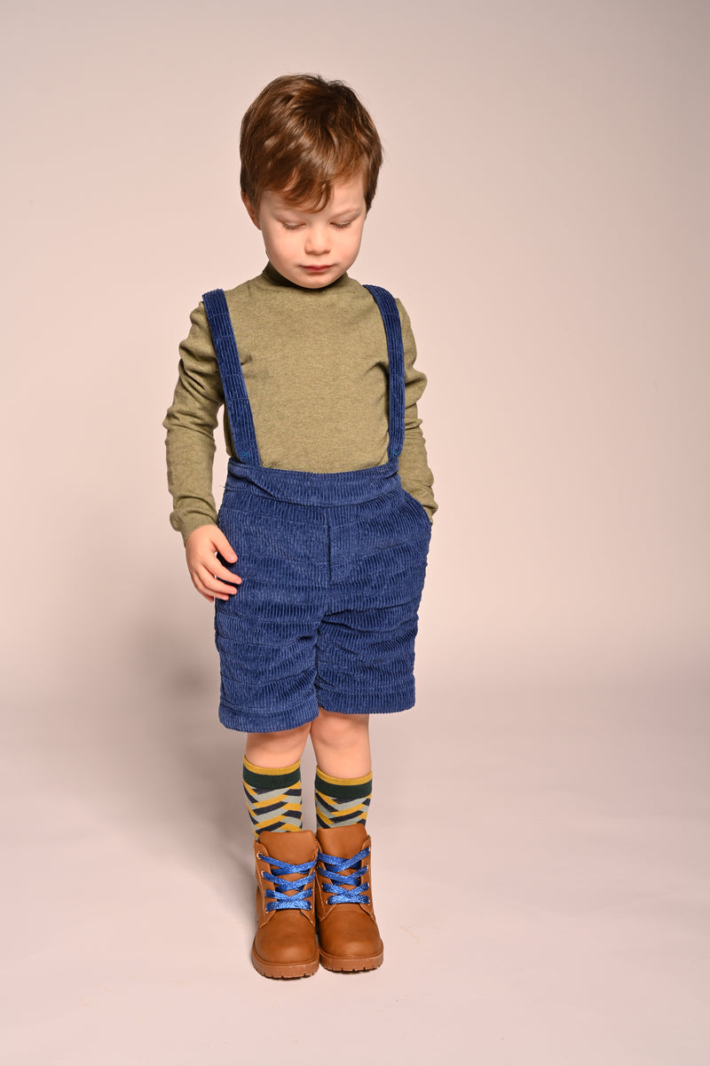 boy wearing blue cotton corduroy padded shorts with suspenders