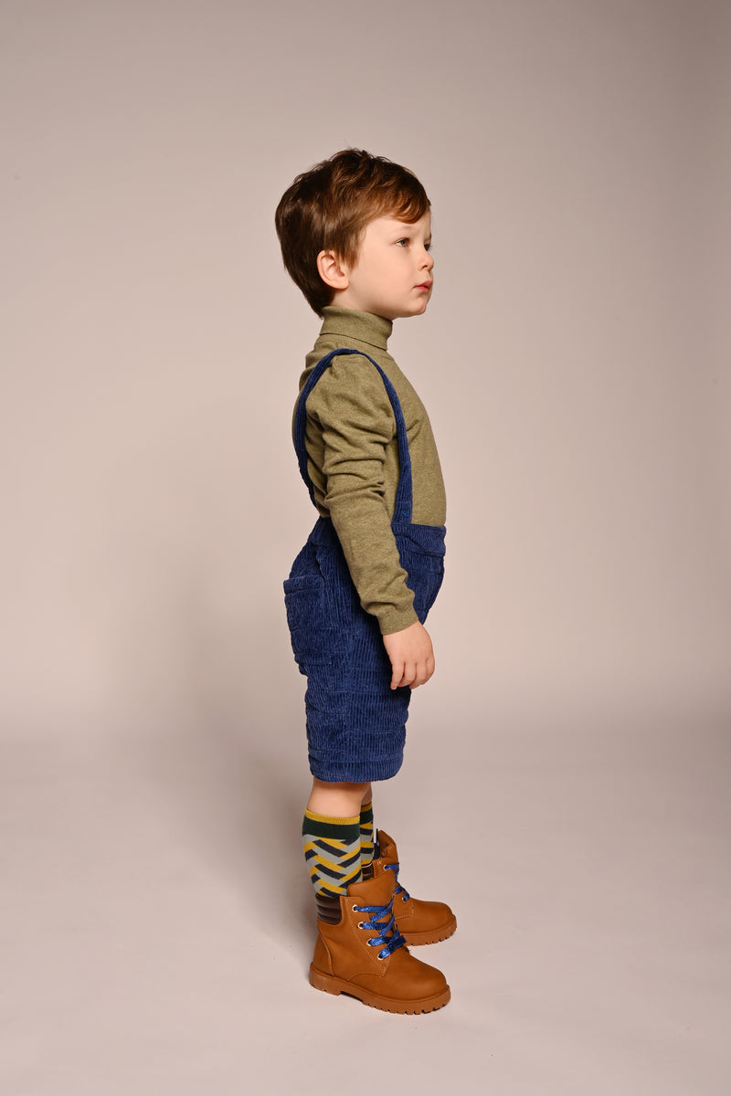 boy wearing blue cotton corduroy padded shorts with suspenders