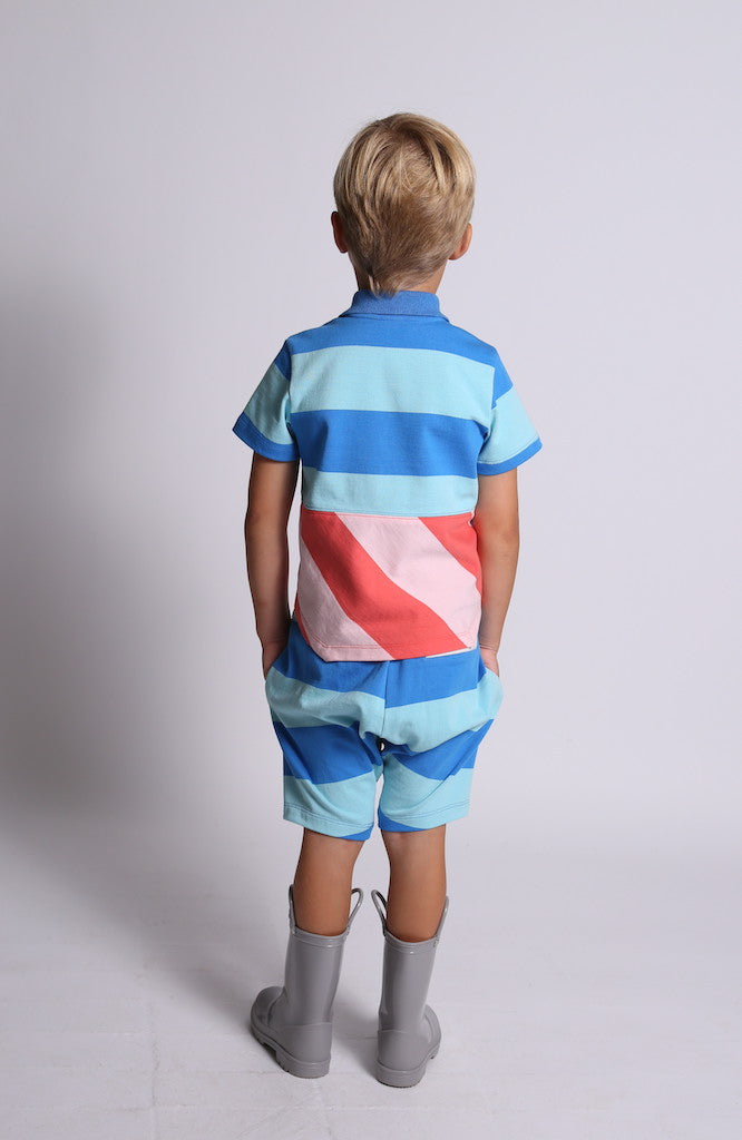boy wearing polo shirt, blue, red, pink, stripes short sleeve, skewed hem, back