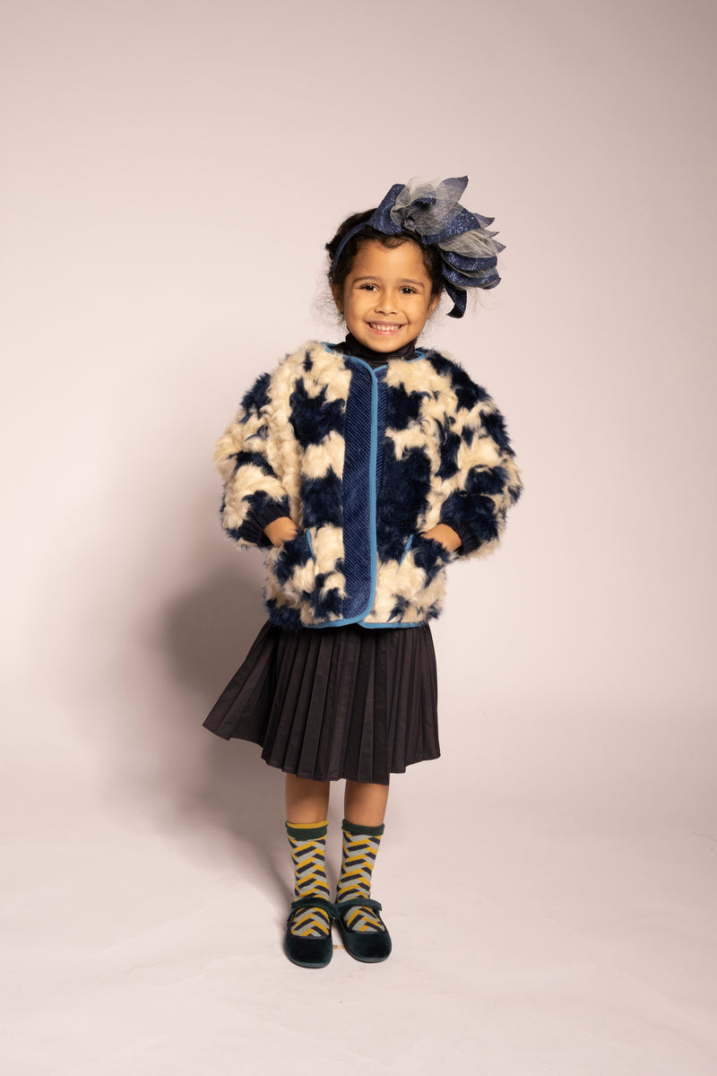 girl wearing blue and white faux fur padded fall coat