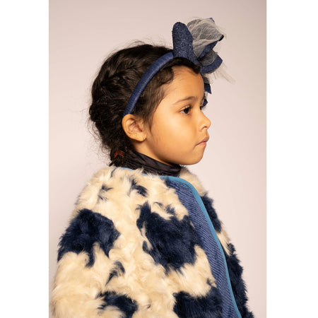 girl wearing blue and white faux fur padded fall coat