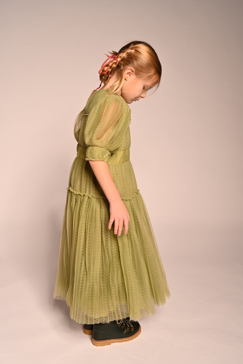 girl wearing green tulle dress with sleeves