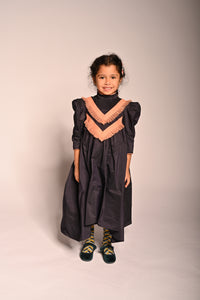 girl wearing dark purple taffeta gown length dress with sleeves