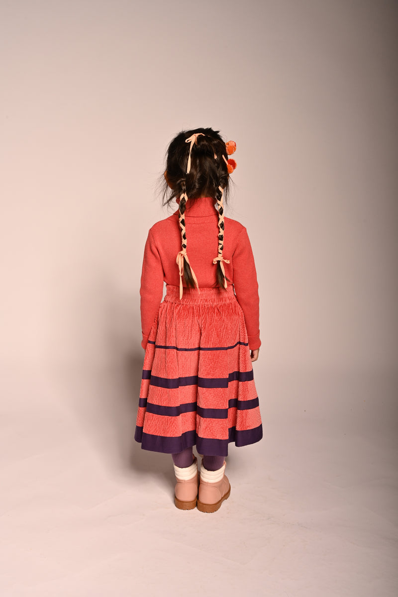 girl wearing red cotton corduroy skirt with purple stripes