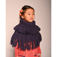 girl wearing purple hand knit wool slip over shrug with tassels