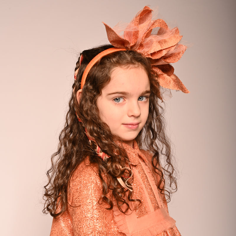 girl wearing orange headband with orange and tulle fabric