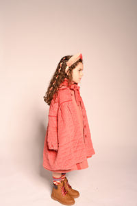 girl wearing red cotton corduroy tufted coat dress