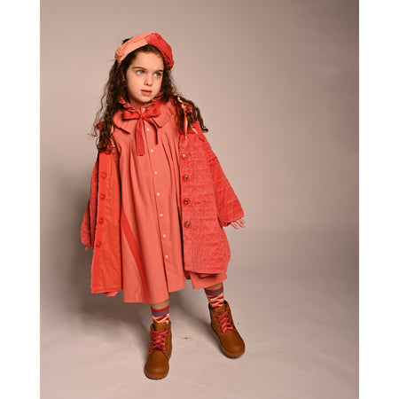 girl wearing red cotton corduroy tufted coat dress