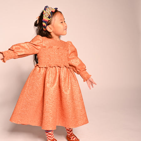 girls orange sparkly smocked dress with long sleeves