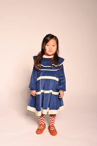 girl wearing blue cotton corduroy dress with sleeves and white stripes