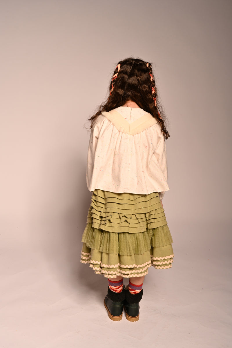 girl wearing green cotton layered with tulle skirt