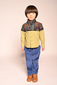 boy wearing green button up collared shirt with printed fine corduroy on the shoulders