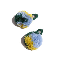 two barrette hair clips with a green blue and yellow pom pom