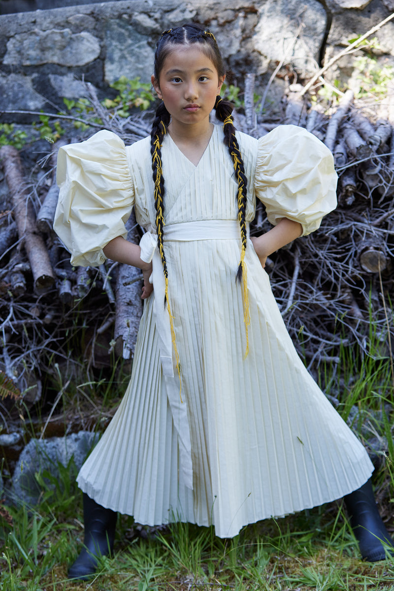 girl wearing white pleated taffeta dress