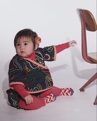 video of baby wearing cotton corduroy padded cross wrap shirt with all over print