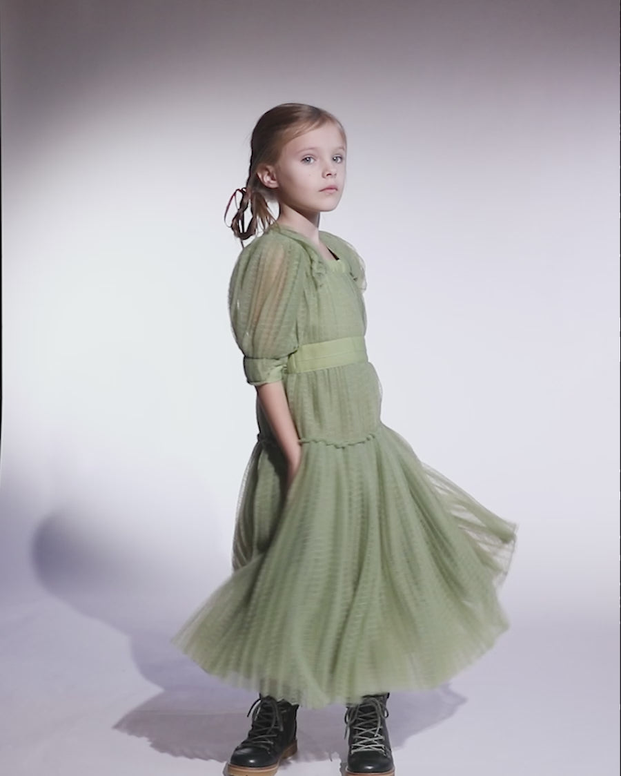 video of girl wearing green tulle dress with sleeves