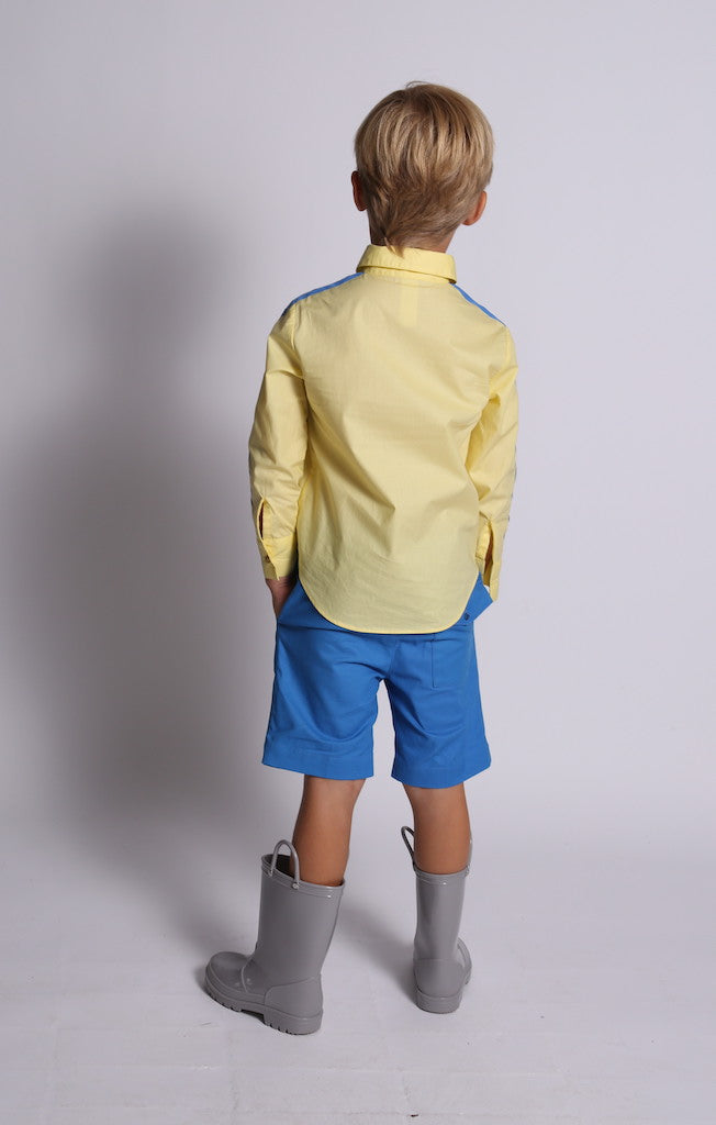 boy wearing yellow button down shirt, blue detailing, snap buttons, back