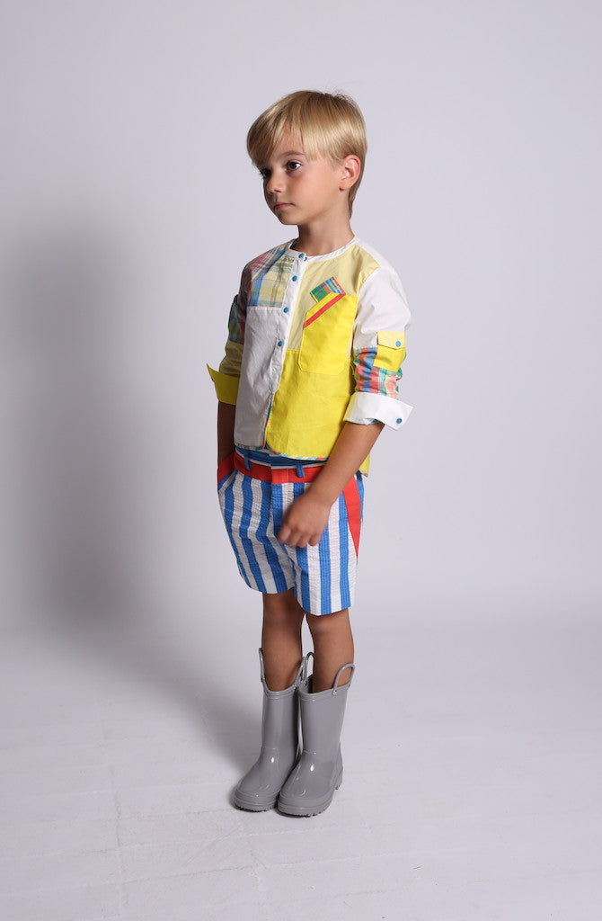 boy wearing yellow henley top, plaid patchwork, side