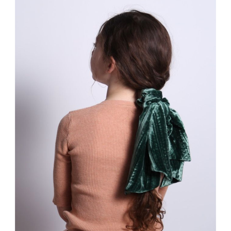 girl wearing green silk velvet scrunchie with tassels